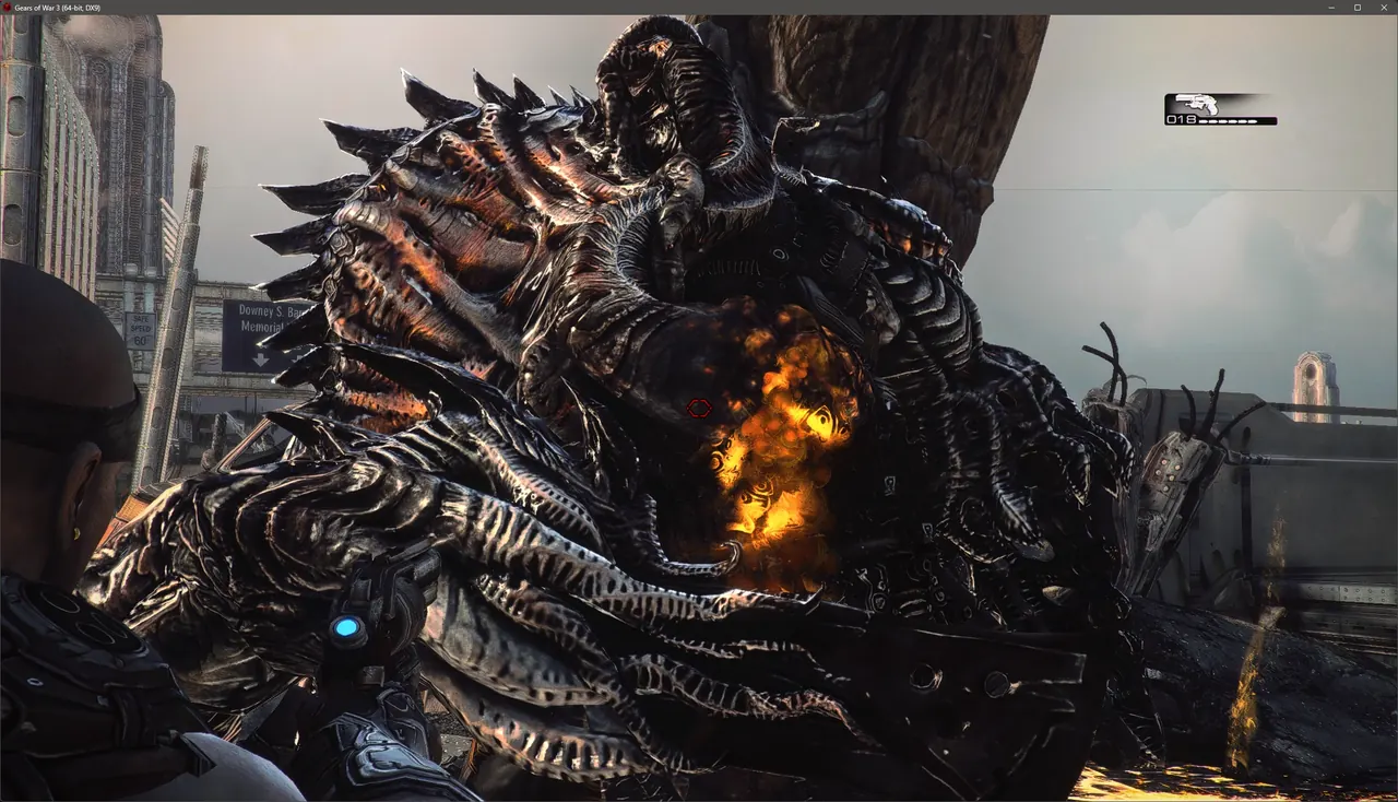 Gears of War 3 with the HD Textures Pack: a large armoured enemy and flames